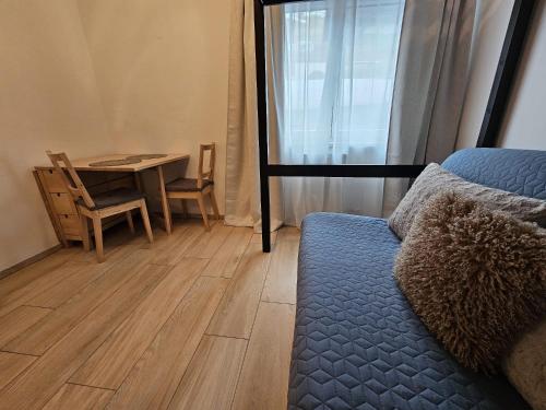 a room with a bed and a table and a desk at Cozy studio in Hinterglemm in Saalbach-Hinterglemm