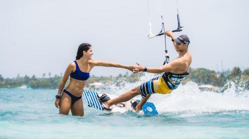 a man and a woman are in the water at Sea Avenue Hotel in San Andrés