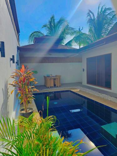 a swimming pool in the middle of a house at Bali Villas Panglao Bohol in Panglao