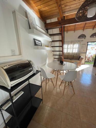 a living room with a table and a piano at Hospedaje en zona centro! in Esquina