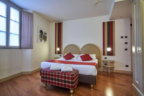 a bedroom with a large bed and a table at Hotel Centrale Best Western Signature Collection in Tirano