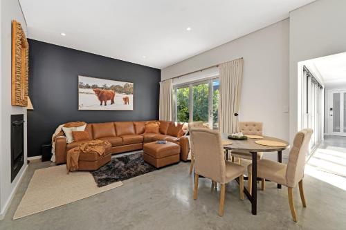 a living room with a couch and a table at The Hidden Door Bowral Villa -the Love of Old Bowral in Bowral