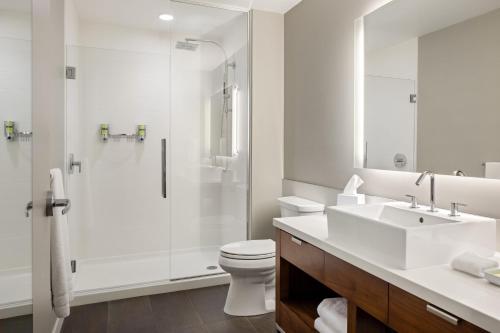 a white bathroom with a sink and a shower at Element Bozeman in Bozeman