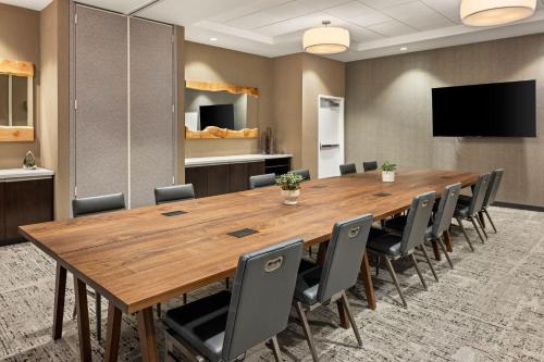 a conference room with a large wooden table and chairs at Element Bozeman in Bozeman