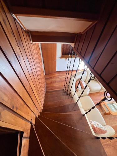 an overhead view of a wooden staircase with chairs at Casa andina in Esquel