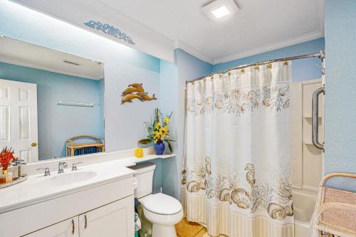 a bathroom with a toilet and a shower curtain at Tressa Terrace in Avon
