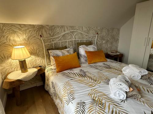 a bed with pillows and a lamp on a table at Casa do Cruzeiro in Aldeia