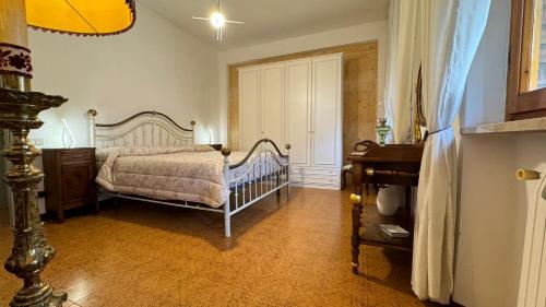 a bedroom with a bed and a dresser in it at CASA GIOVANNI in San Gimignano