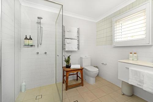 un bagno con wc e doccia in vetro di The Hidden Door Bowral Cottage - The Love of Bowral a Bowral