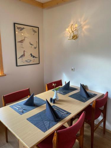 a dining room table with blue napkins on it at Bakkaflöt Guesthouse in Varmahlid