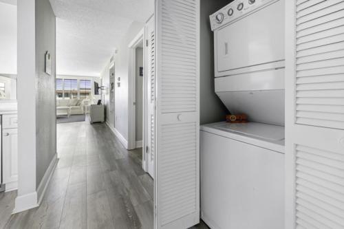 a kitchen with white cabinets and a dishwasher at Loggerhead 314 condo in Sanibel