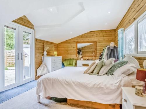 a bedroom with a bed in a room with wooden walls at Dai Boy Cabin - Uk46403 in Cowbridge
