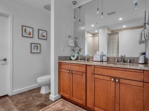 a bathroom with a sink and a toilet at 2/2 PENTHOUSE DOWNTOWN with large Billiard room in Orlando