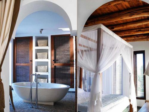 カラ・ヴァデラにあるBeautiful holiday home with private poolのバスルーム(バスタブ付)、ベッドルーム(ベッド付)が備わります。