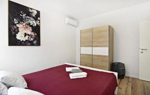 a bedroom with a bed with towels on it at Family friendly house with a swimming pool Buroli, Umag - 22400 in Umag