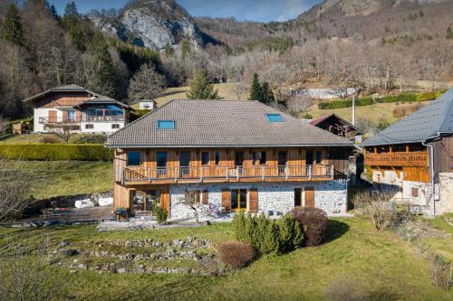 an aerial view of a large house in the mountains at La Ferme des Artistes - OVO Network in Mieussy