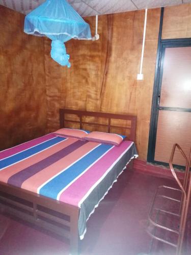 a bedroom with a bed in a room at Naaval Beach Villa & Rooms in Batticaloa