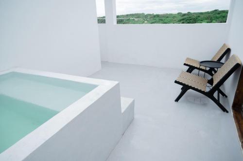 two benches sitting on the roof of a house at Woywoy Paradise in Bira