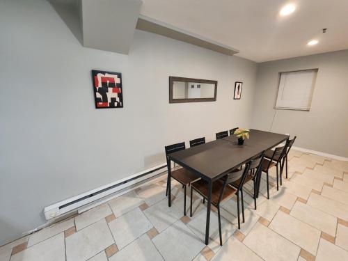 a dining room with a black table and chairs at Cozy & Classy 1-Bed Close to NYC in Jersey City