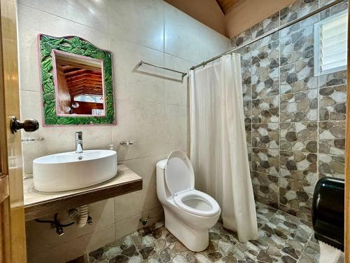 a bathroom with a toilet and a sink at San José del Pacífico Camino al Cielo C3 in San Jose del Pacifico
