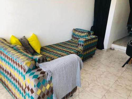 ein Sofa und ein Stuhl im Wohnzimmer in der Unterkunft @casa_grace Bienvenidos! in Cartagena de Indias