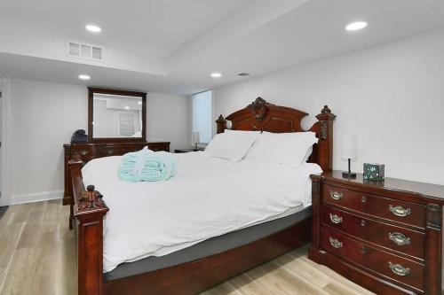 a bedroom with a large bed and a dresser at Centered Home in West Springfield