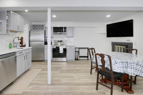 a kitchen and dining room with a table and chairs at Centered Home, 1st floor in West Springfield