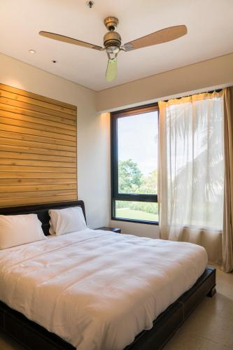a bedroom with a large bed and a window at Villa seaview and apartment -Spa Da Nang Resort by JT group "Free pick up" in Da Nang