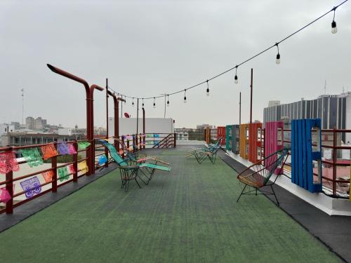 a group of benches on the roof of a building at Casa Eufemia Hostel type in Mexico City