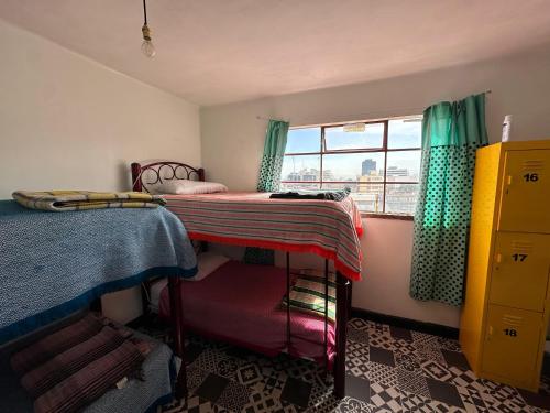 a bedroom with two bunk beds and a window at Casa Eufemia Hostel type in Mexico City
