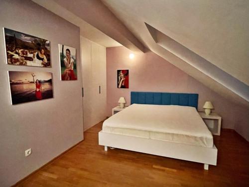 a bedroom with a white bed and pictures on the wall at Villa Tamara in Zavala