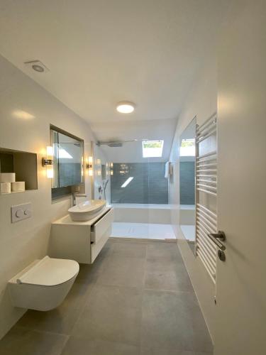 a bathroom with a toilet and a sink and a shower at Villa Tamara in Zavala