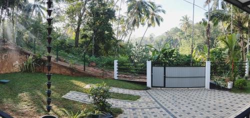 a garden with a gate and a fence at Serene Bliss Villa in Unawatuna