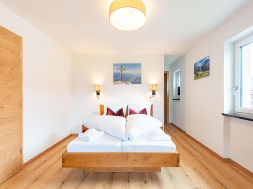 a bedroom with a white bed in a room at Apartment in Uderns near Spieljoch Ski in Uderns