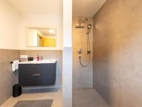 a bathroom with a sink and a shower at Thunhaus Apartments with ski-storage in Uderns