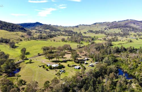 an aerial view of a farm with cows in a field at Barrington Riverside Cottages in Barrington