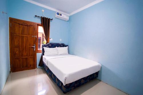 Ένα ή περισσότερα κρεβάτια σε δωμάτιο στο Bayang Brothers Residence By Occupied