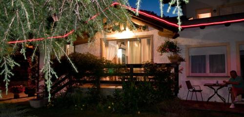 a house with christmas lights on the front of it at La Roche Hotel Appartments in Aosta