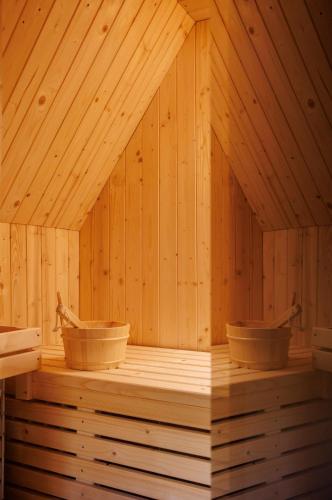 a room of a sauna with two baskets in it at The Cliff Village in Comarnic