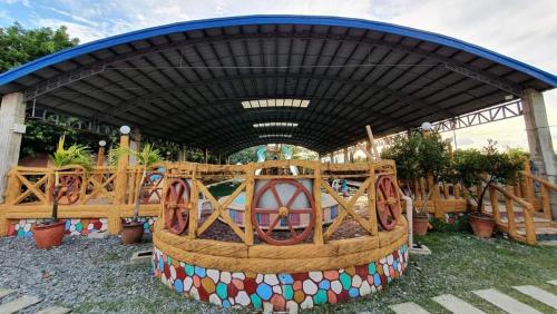 a playground with a ride in a building at Arzel Resort in Mangatarem