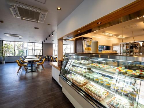 a restaurant with a display case filled with food at APA Hotel Maebashieki-Kita in Maebashi