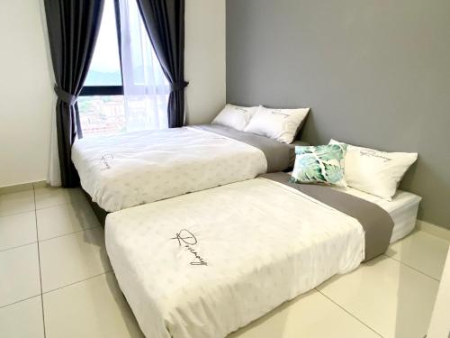 three beds in a room with a window at Decozy 8.0 IpohTownCondo (10pax) in Ipoh