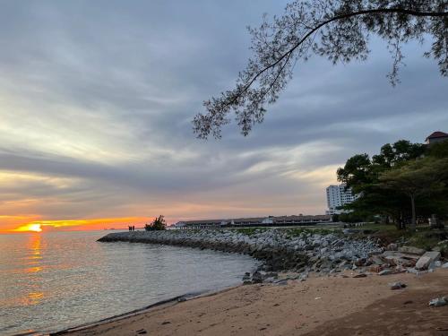 a view of a beach with the sun setting at DE WHITE HOMESTAY . PORT DICKSON in Port Dickson