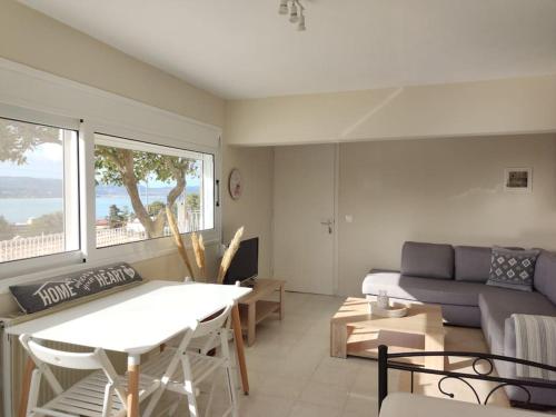a living room with a couch and a table at Horizon Seaview Apartment in Lassi