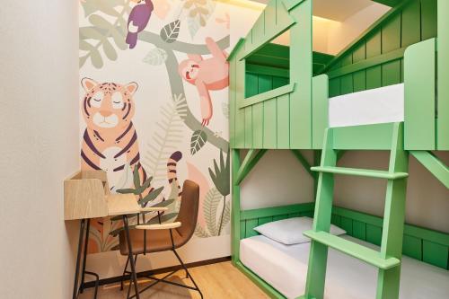 a room with a green bunk bed and a desk at Aloft Beijing Huairou in Huairou