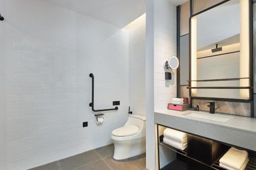 a bathroom with a toilet and a sink at Aloft Beijing Huairou in Huairou