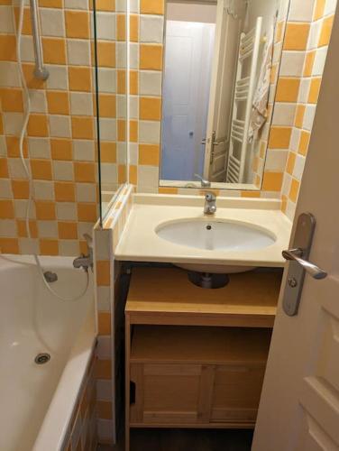 une salle de bain avec un lavabo, un miroir et une baignoire dans l'établissement Superbe appartement Cannes avec Piscine 1 chambre, à Cannes