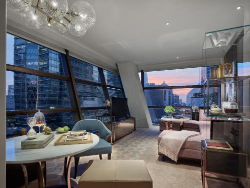 a living room with a view of a city at Rosewood Bangkok in Bangkok