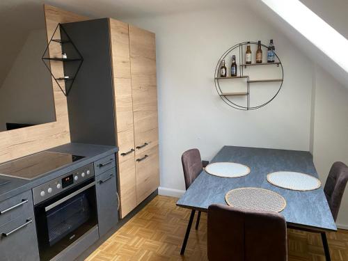 a kitchen with a table with chairs and a stove at Schönes Apartment mit Aussicht über Graz in Graz