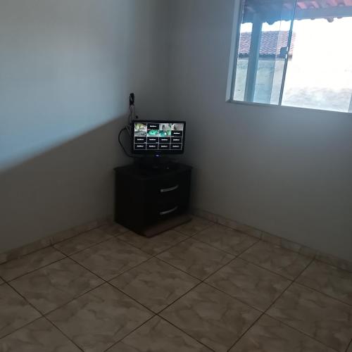 a corner of a room with a television on a table at Condomínio vale Araçás in Mateus Leme